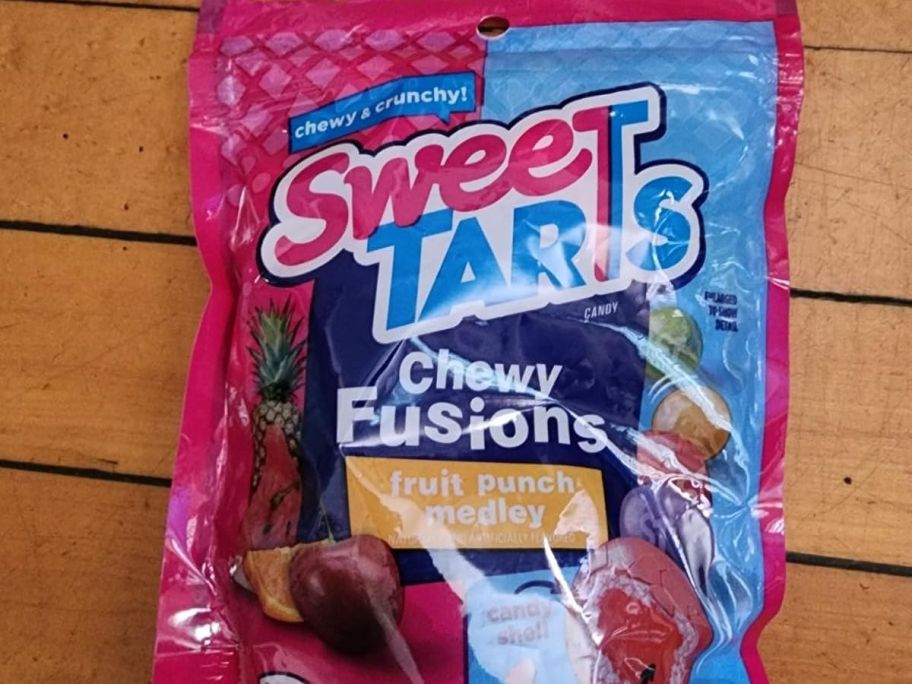 a bag of SweeTARTS Chewy Fusions Candy Fruit Punch Medley laying on a wood top table