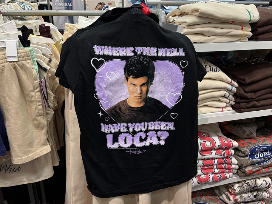 Black Twilight graphic T-shirt at Target featuring Jacob Black and the quote “Where the hell have you been, loca?” displayed on a clothing rack.