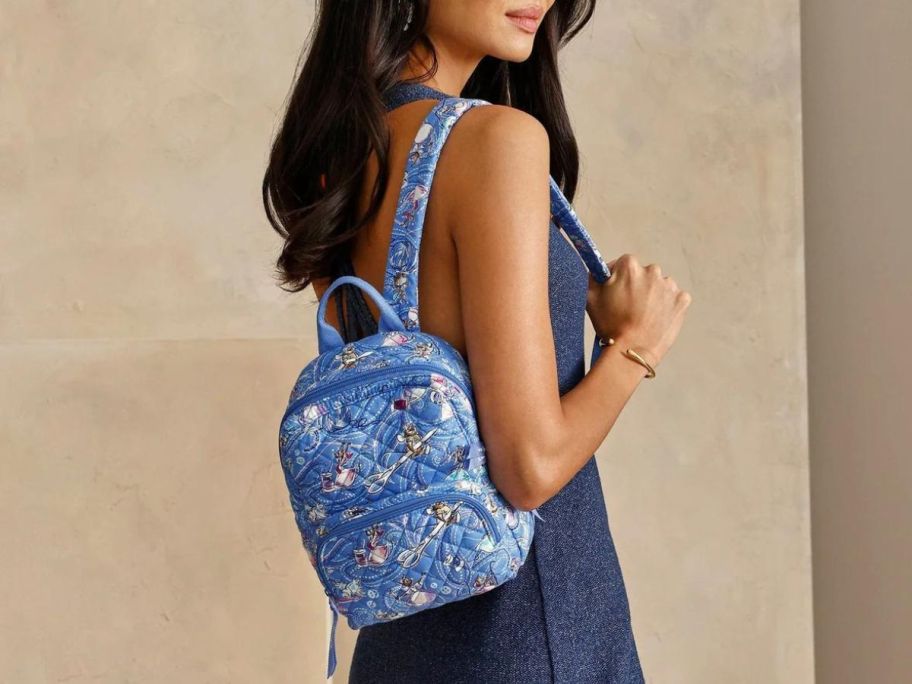 Woman wearing a Vera Bradley Cinderella Mini Backpack