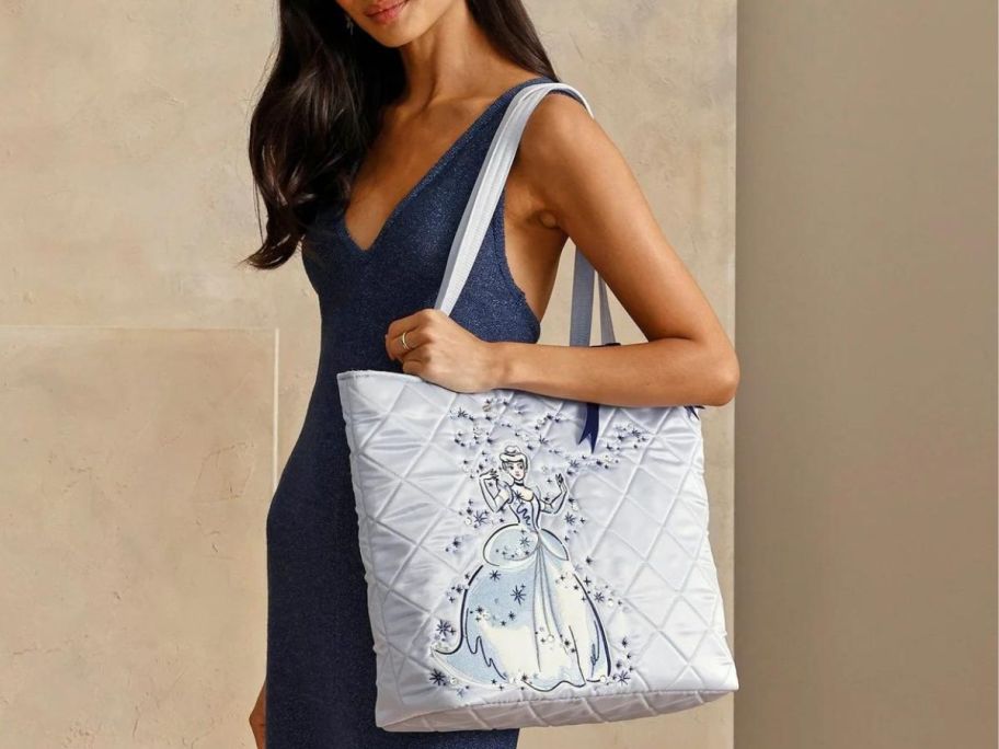 Woman wearing a xDisney Vera Bradley Cinderella Tote Bag