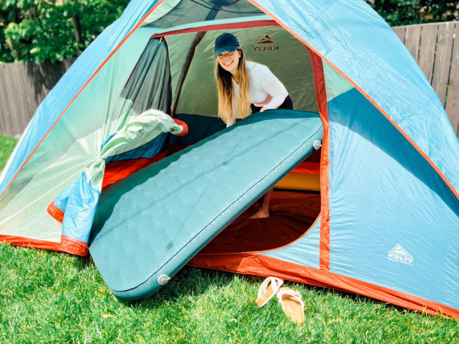 WOman using large camping mattress