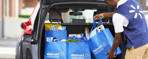 placing walmart groceries in back of car