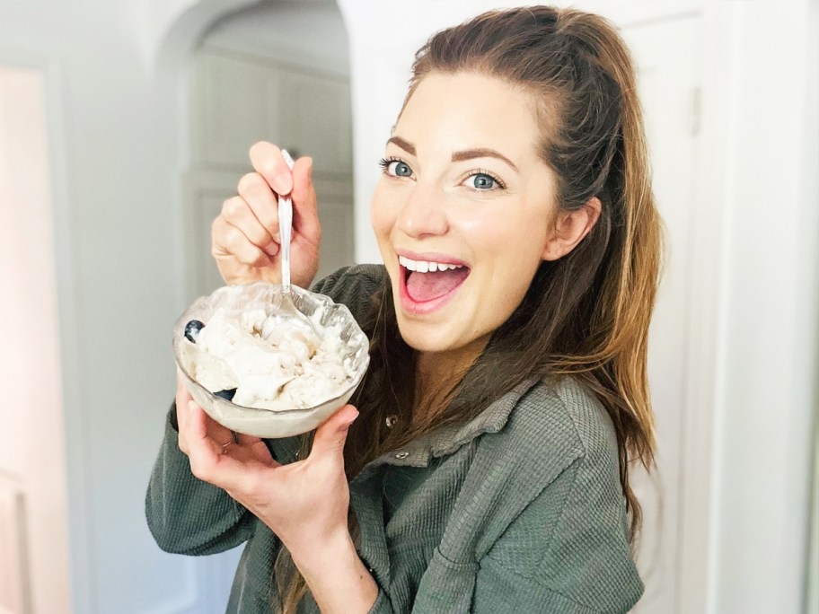 woman holding up a bowl of soft serve