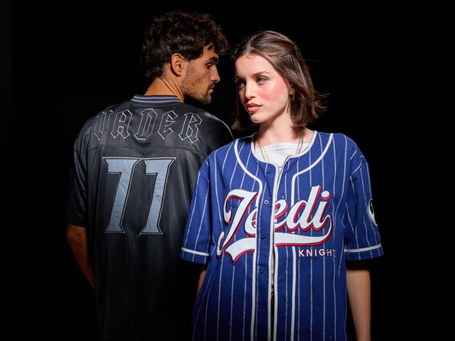 two people wearing Star Wars jerseys on a black background