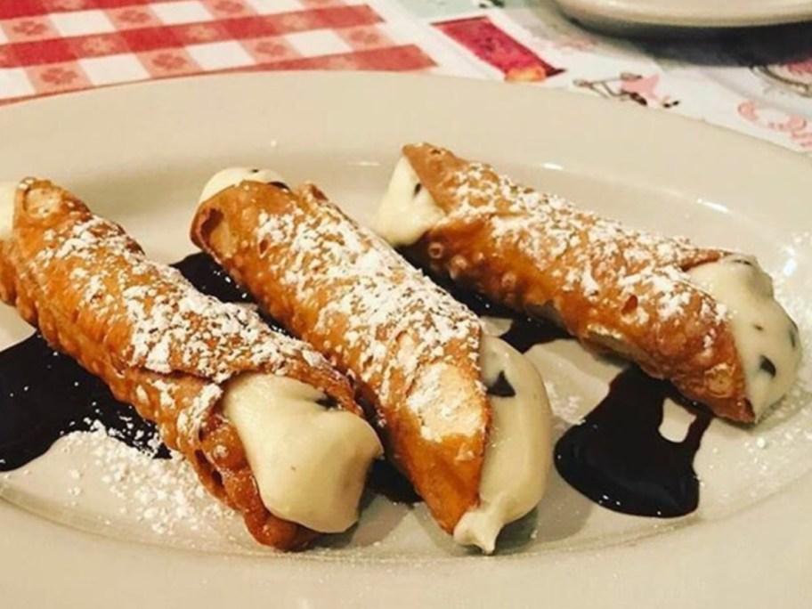 three cannolis on plate