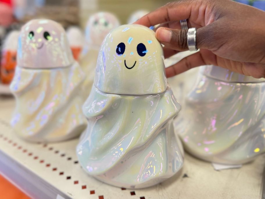 a womans hand displaying a ceramic ghost shaped food safe vessel