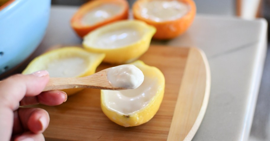 eating a lemon sorbet cup with a spoon