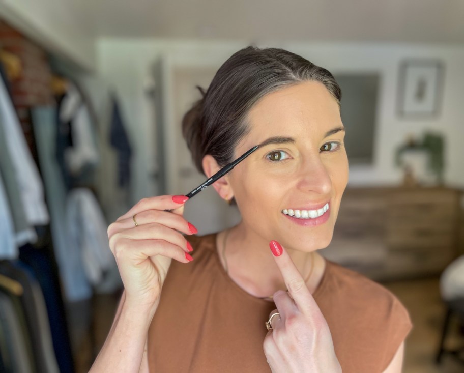 Woman using the precise eyebrow pencil from elf Cosmetics which is makeup available at Walmart