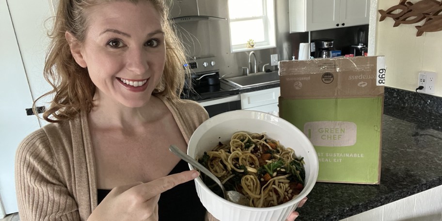 kara holding bowl of food with green chef box in background