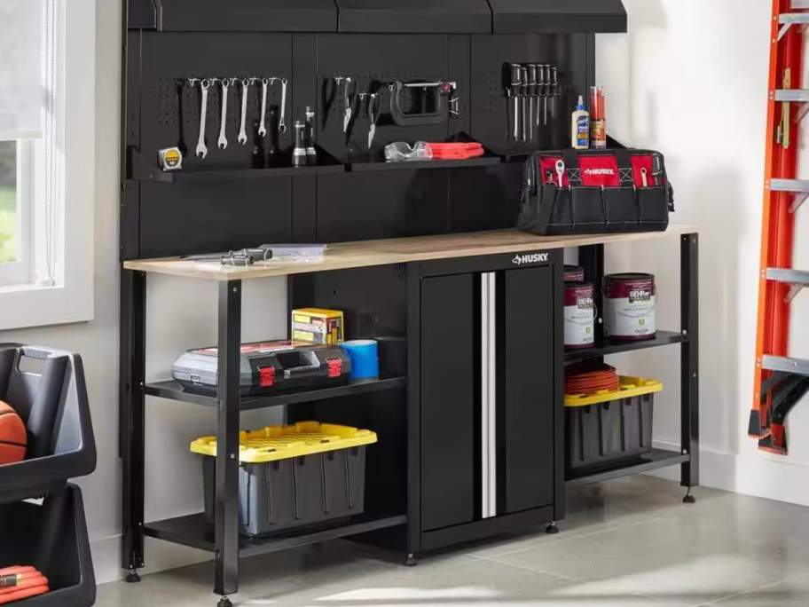 black huskey workstation in garage full of tools 