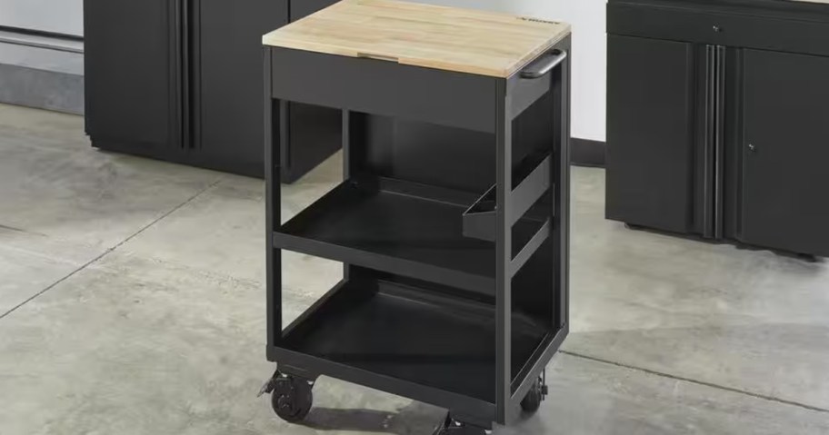 black husky workbench on wheels with wooden top in garage 