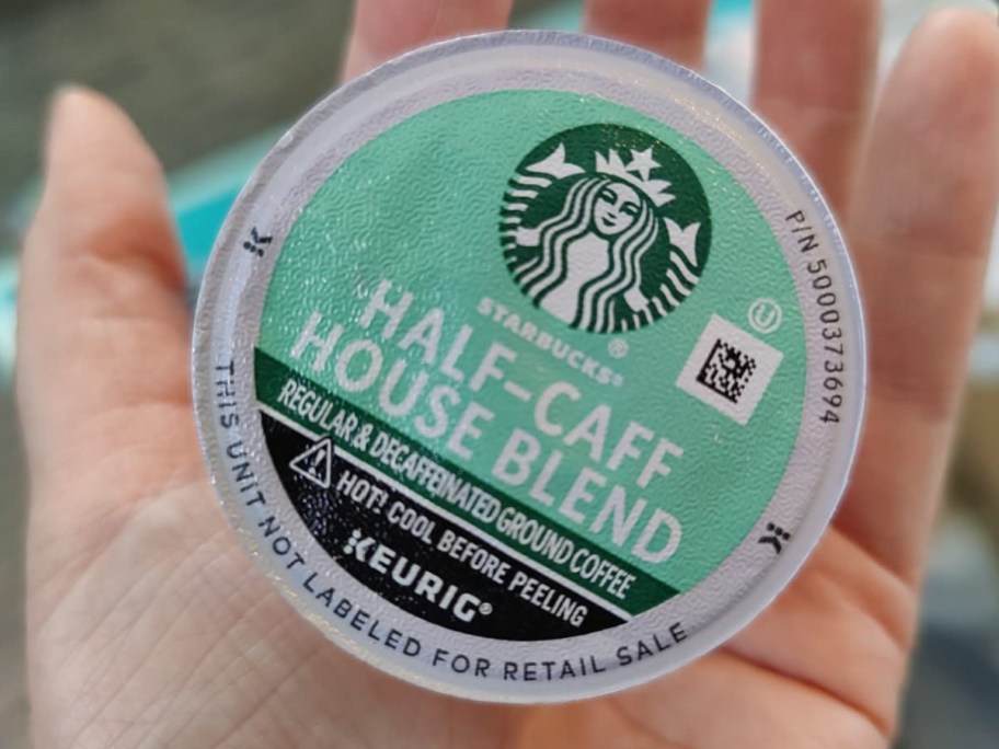 image of Starbucks K-Cup Medium Roast Half-Caff Coffee Pods in persons hand