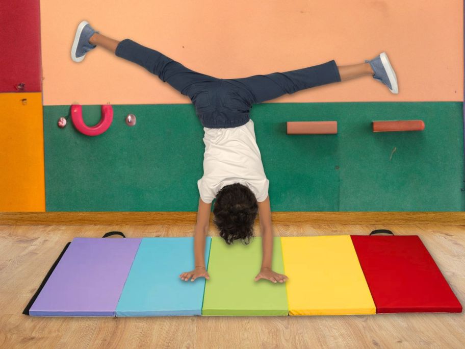 child doing a somersault on tumbling mat