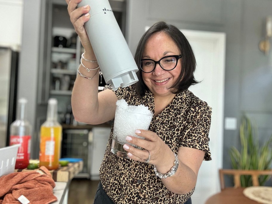 woman using ice shaver to fill cup with ice