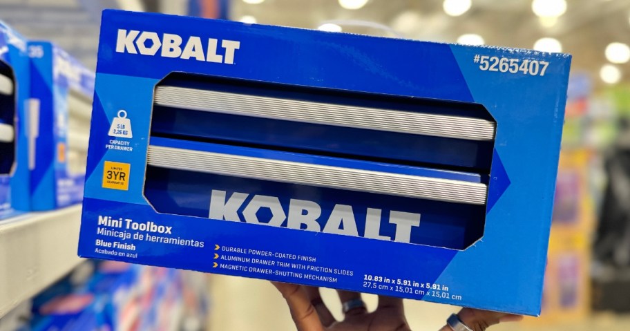 hand holding a blue box with a blue Kobalt mini toolbox in it in a Lowes store aisle