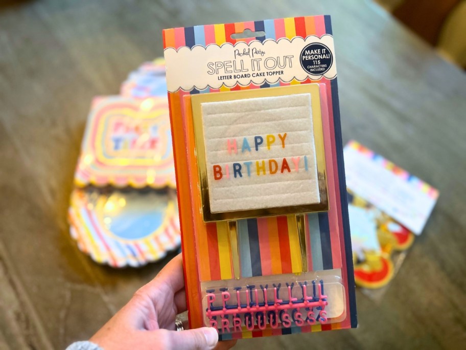 hand holding a happy birthday letterboard cake decor