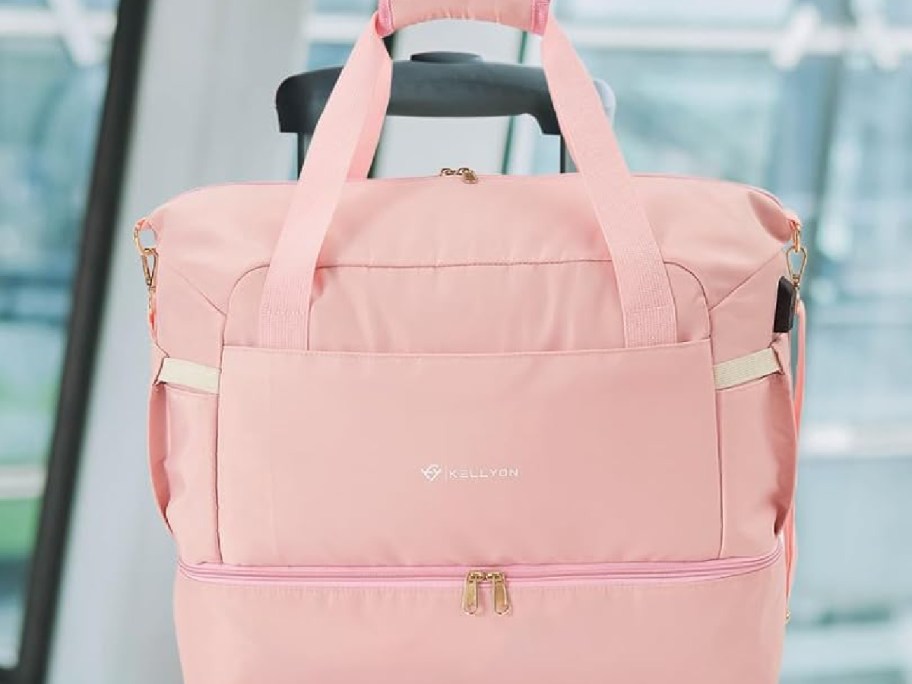 pink travel bag displayed on a suit handle