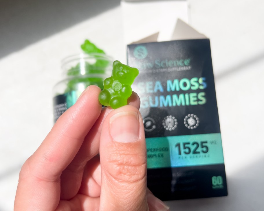 hand grabbing gummy bear vitamin