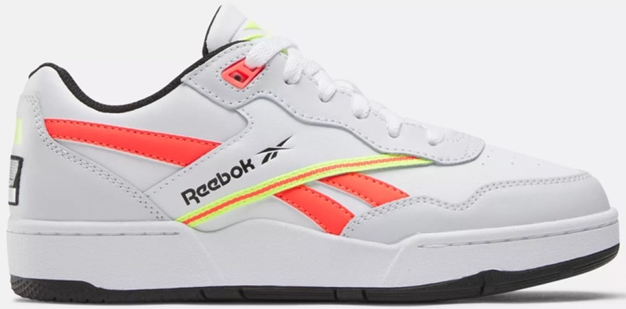 white, orange and yellow reebok kids shoe