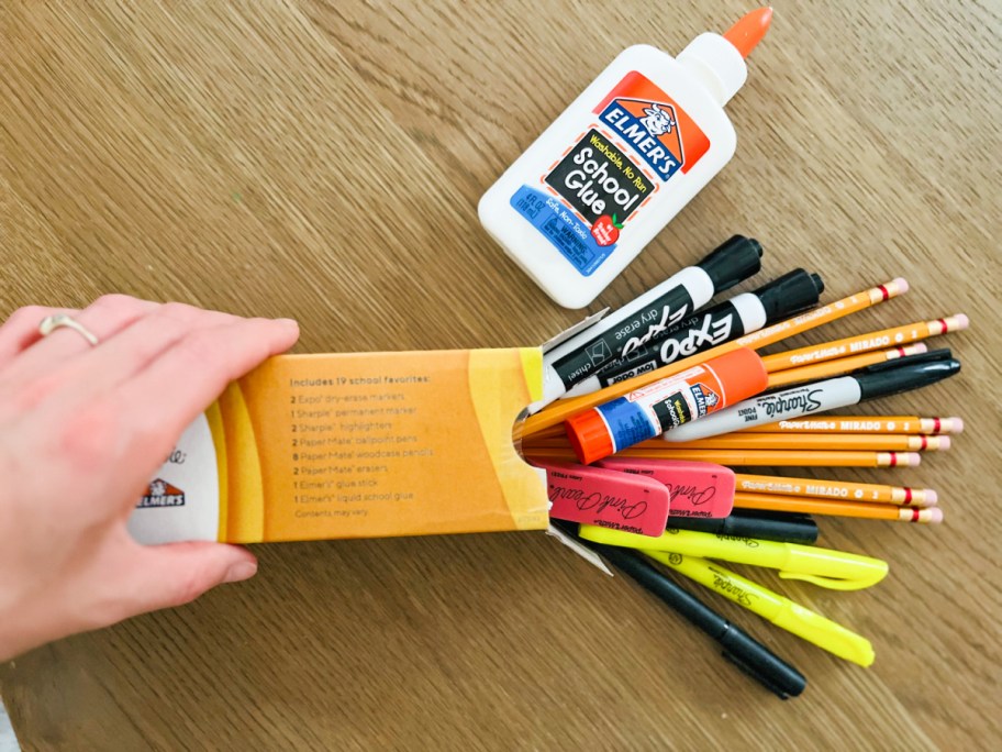 hand holding a box from staples full of school supplies for teacher appreciation week