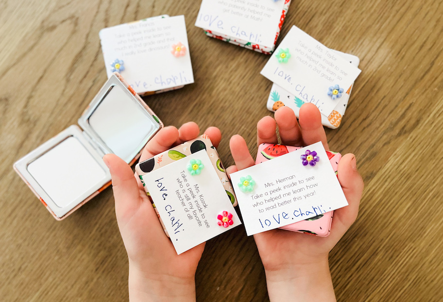 childs hands holding notes for teacher gift ideas with fruit themed onlinepact mirrors