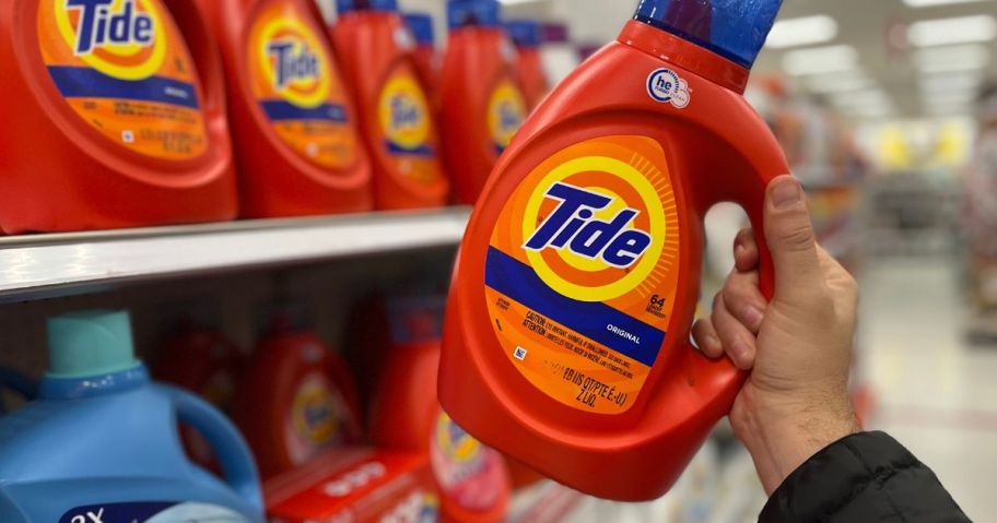 tide bottle being held by hand in store