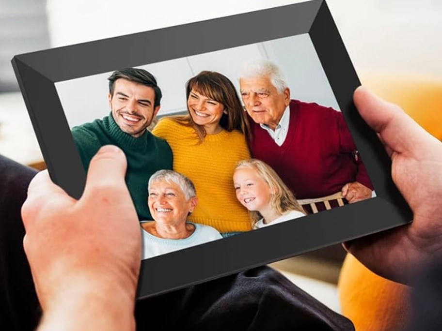 hands holding black digital frame