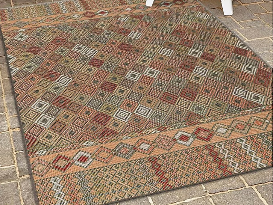 area rug laying on ground outdoors 