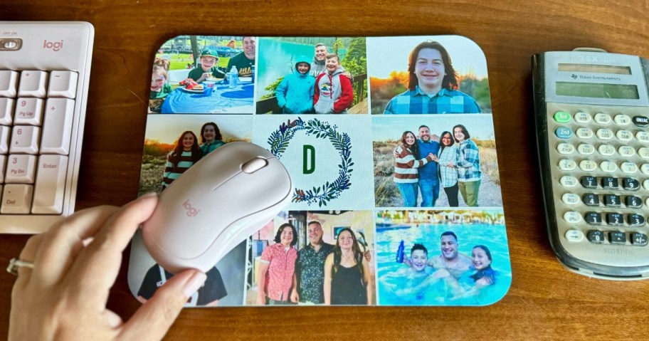 person's hand on a onlineputer mouse that's on a custom photo mousepad