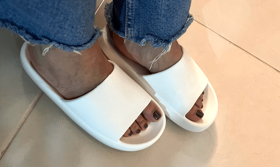 woman wearing white cloud slides 