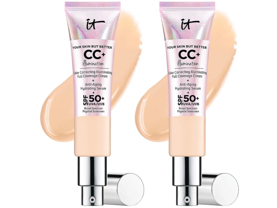 2 tubes of IT Cosmetics CC Cream with the cream spread out behind it