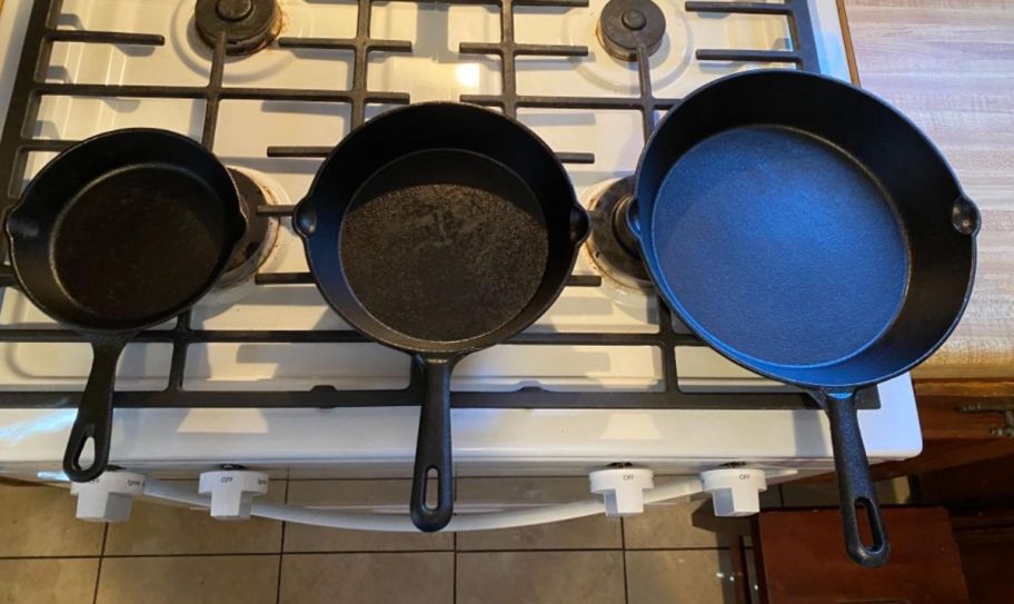 3 piece iron skillet set on a stove top