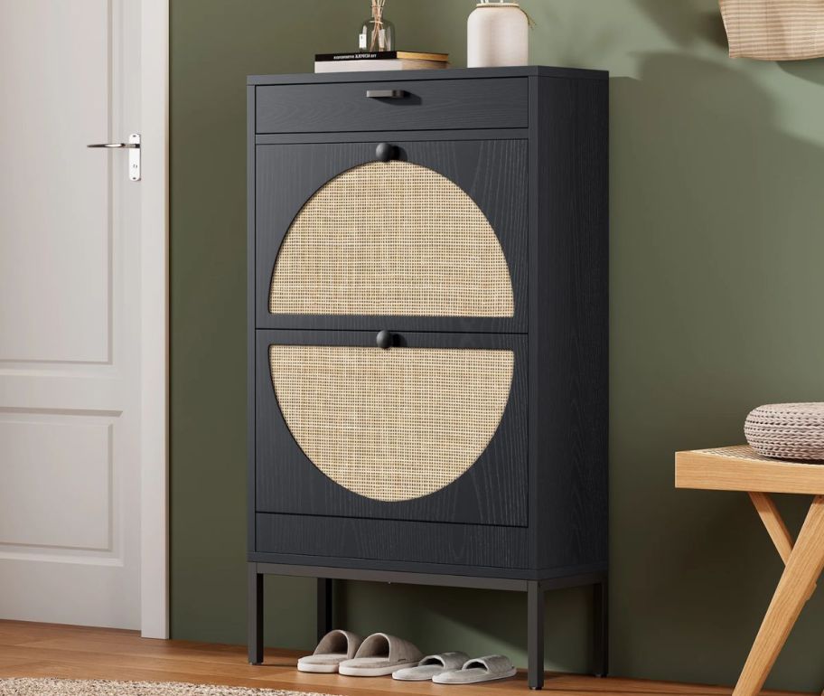 a black and natural rattan shoe cabinet