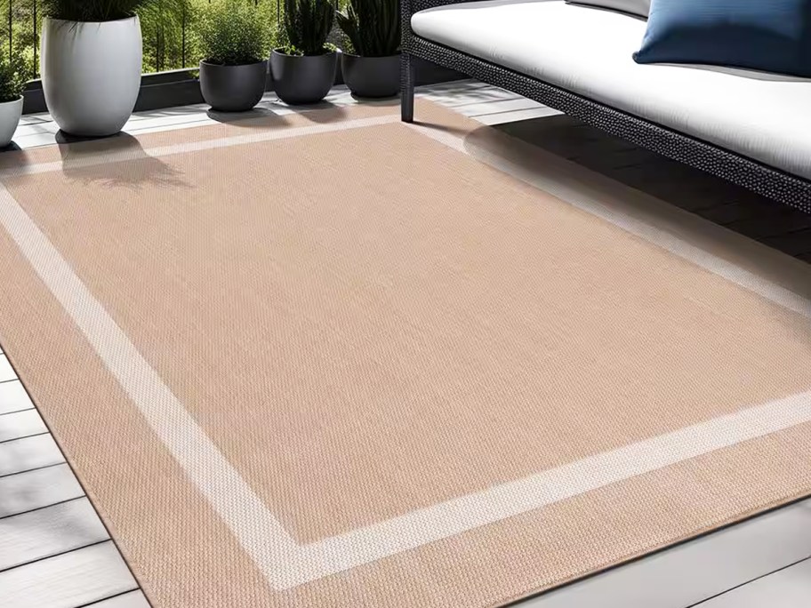 beige area rug with white border