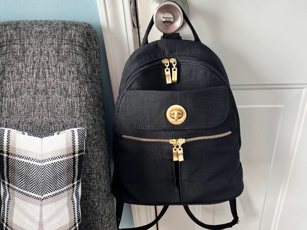 Black backpack hanging on door