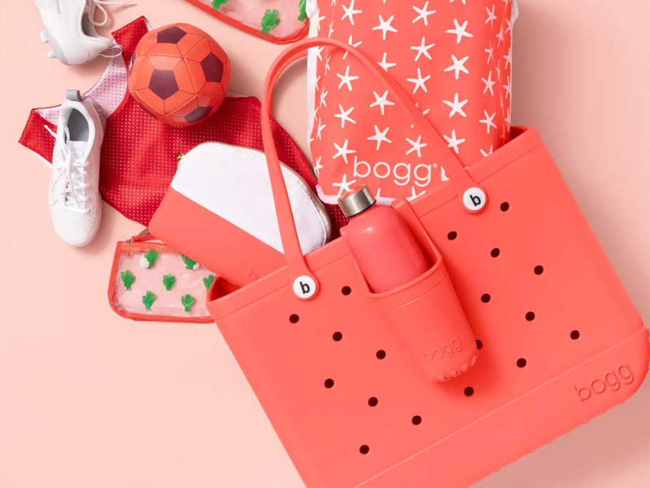 pink bogg bag filled with accessories