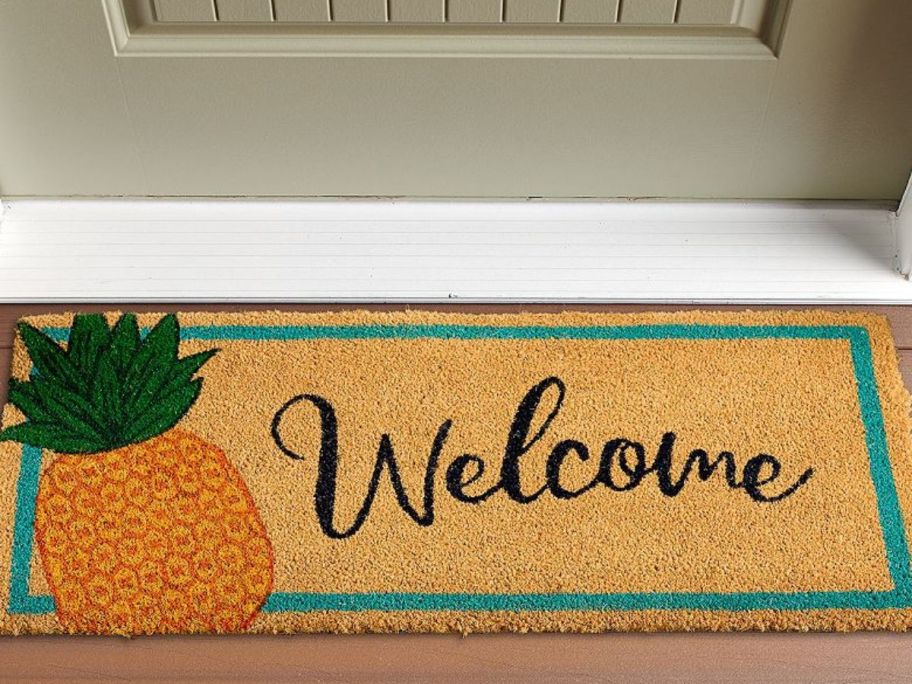 A coir welonlinee mat with a pineapple on it