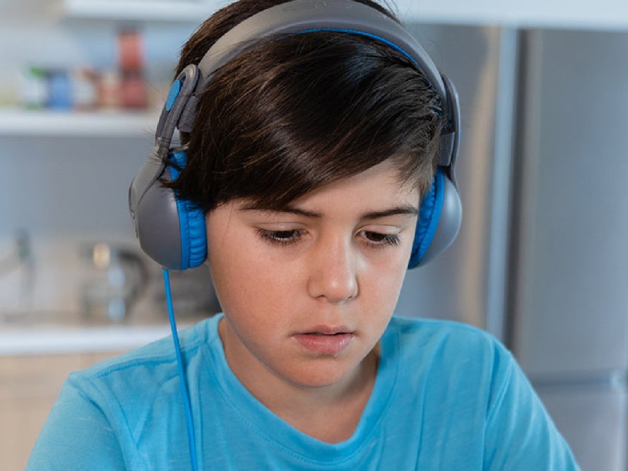 Child wearing overhead headphones in blue