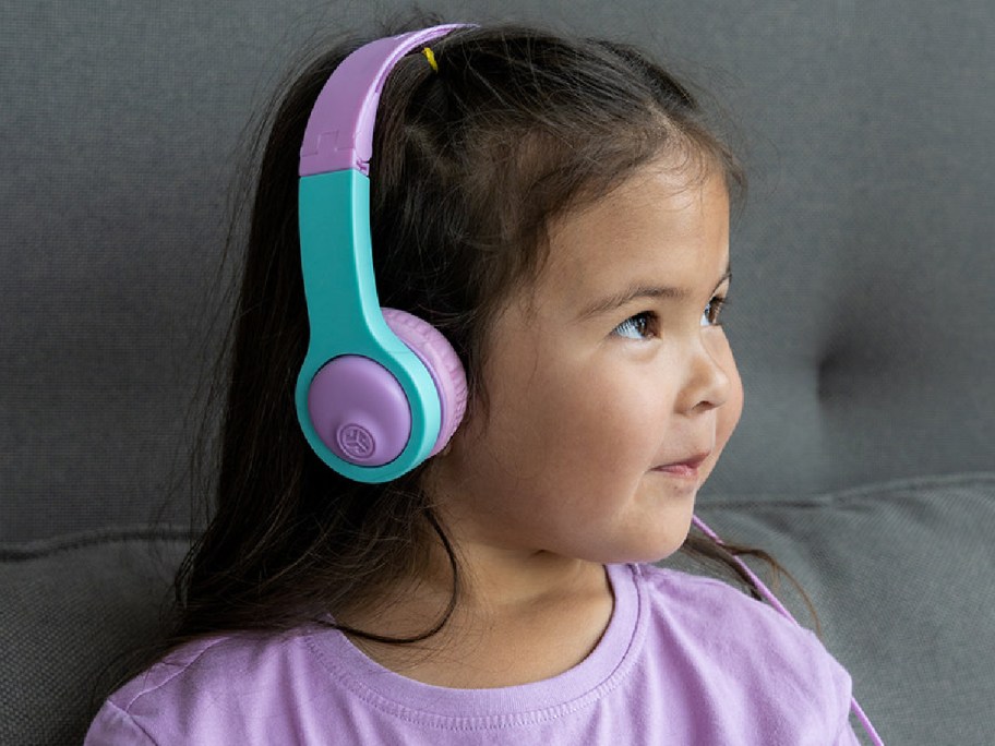 Child wearing overhead headphones in purple and blue