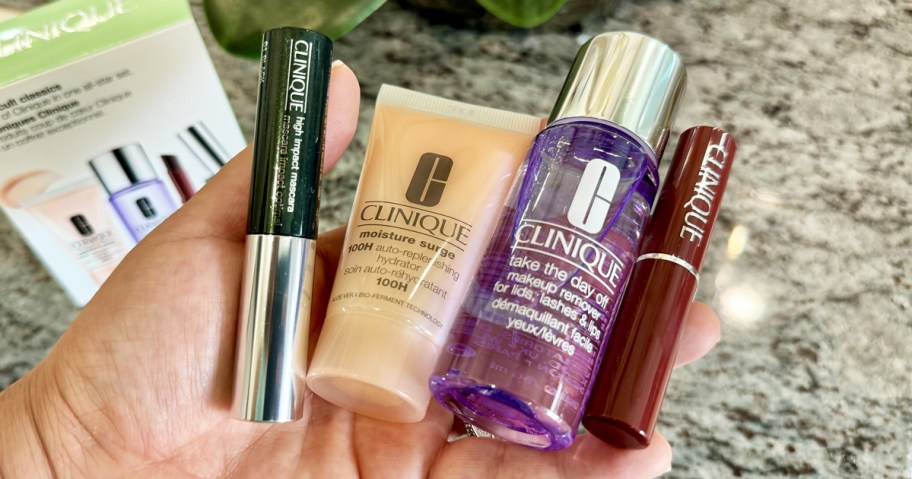 hand holding 4 mini clinique products