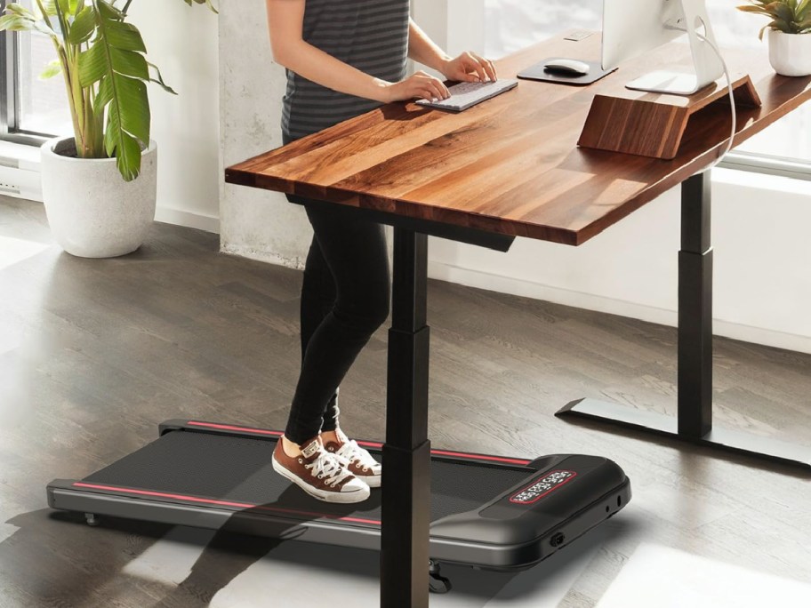 Person at standing desk on walking treadmill 