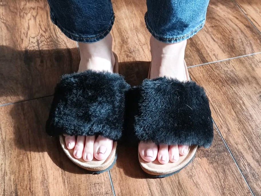 woman wearing fuzzy black slipper slides