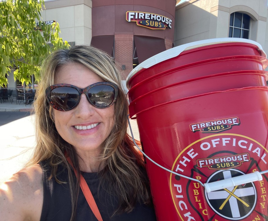 Woman holding a Firehouse Subs 5 Gallon Pickle Bucket