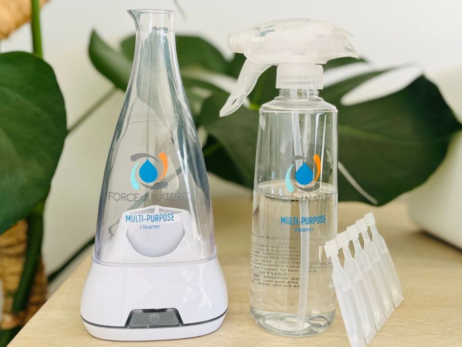 A force of nature starter bundle with appliance, reusable spray bottle and refill capsules