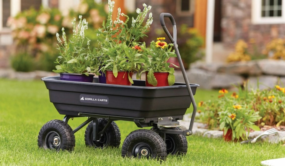 Gorilla Cart 600-Pound Poly Garden Dump Cart carrying plants