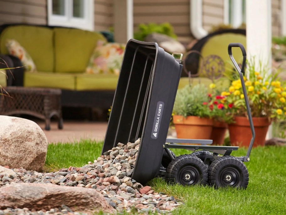 Gorilla Cart 600-Pound Poly Garden Dump Cart dumping out stones