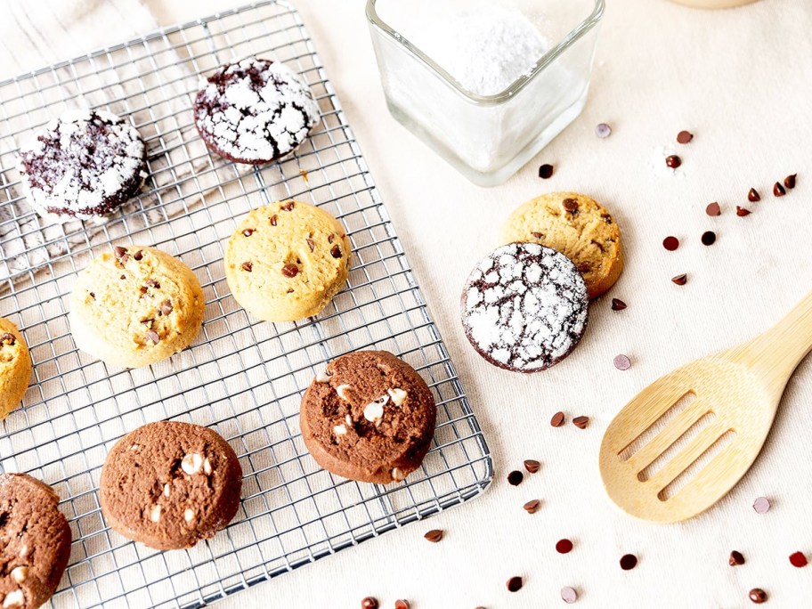 various cookies on cooling rack surrounded by chocolate chips