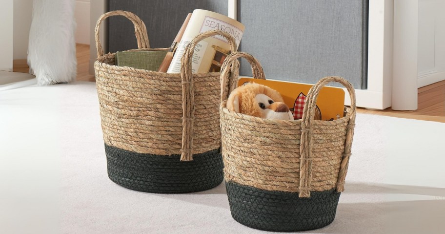 small and medium size tan and black seagrass storage baskets with items in them in a living room