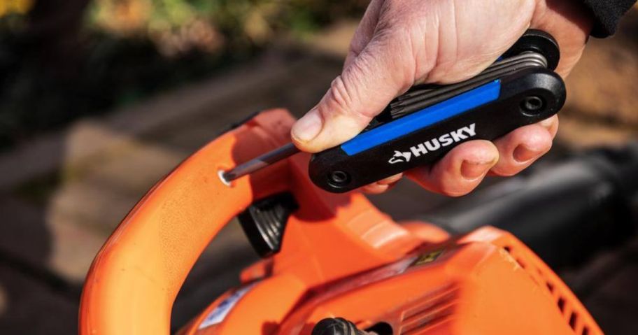 A person using a Husky Hex Key set on a leaf blower