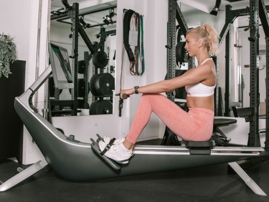 woman using a hydrow rowing machine